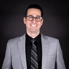 Michael Gordon, a friendly and experienced real estate agent, shaking hands with a happy homeowner.