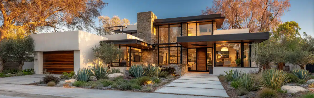 Front facade of a modern luxury home with white stucco and cedar slats, representing premium custom homes design in LA.