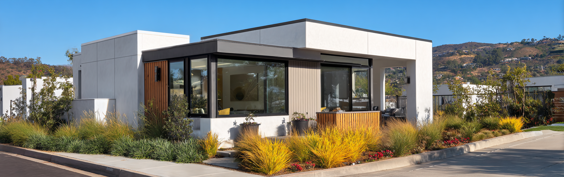 Exterior of a modern ADU Aliso Viejo with white stucco and black window frames.