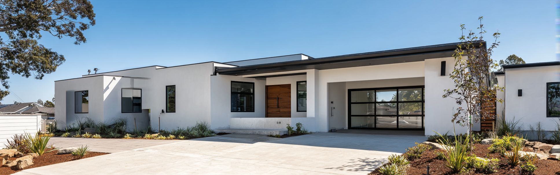 A newly built New Detached in california with white stucco and a flat roof under bright daylight