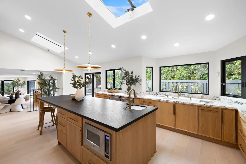 Remodeled chef's kitchen at 1700 Port Ashley Pl Newport Beach with large island and wood cabinetry