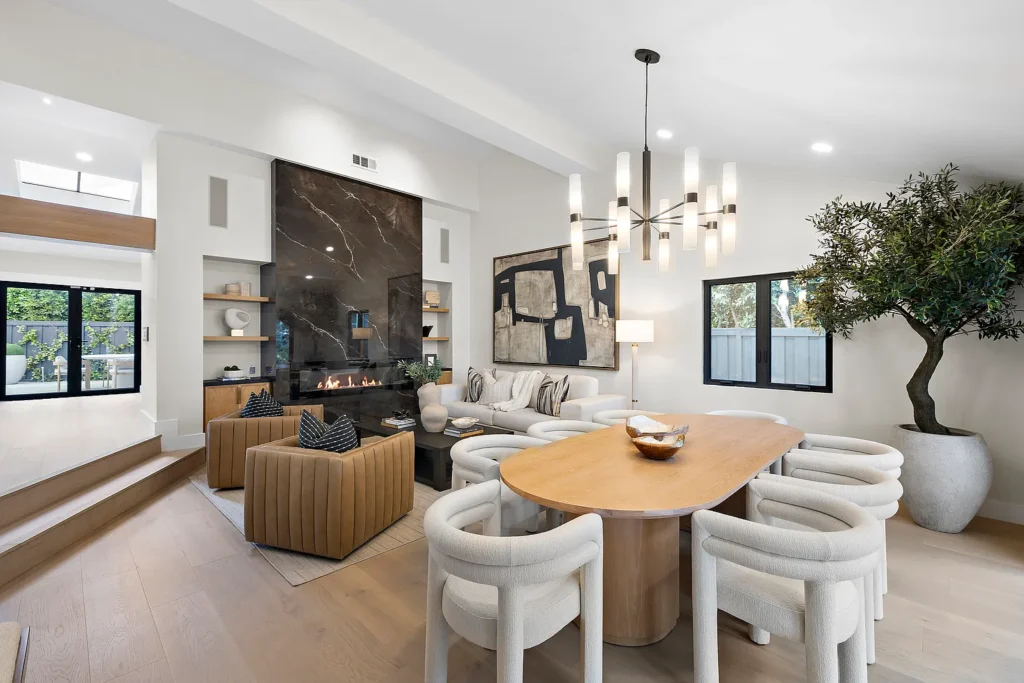 Open-concept living and dining room at 1700 Port Ashley Pl Newport Beach with modern fireplace