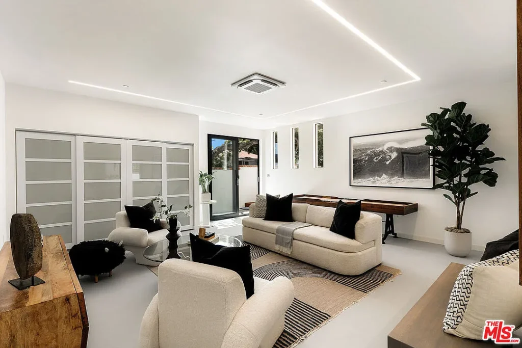 Contemporary living room interior at 2202 California Ave in Santa Monica featuring modern sofas, minimalist decor, large windows, artwork and open architectural design