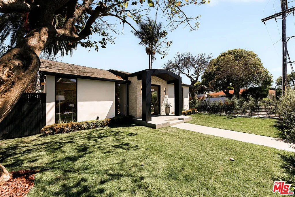 Modern front yard exterior at 2202 California Ave in Santa Monica featuring a landscaped lawn, contemporary entryway, stone facade and minimalist architectural design