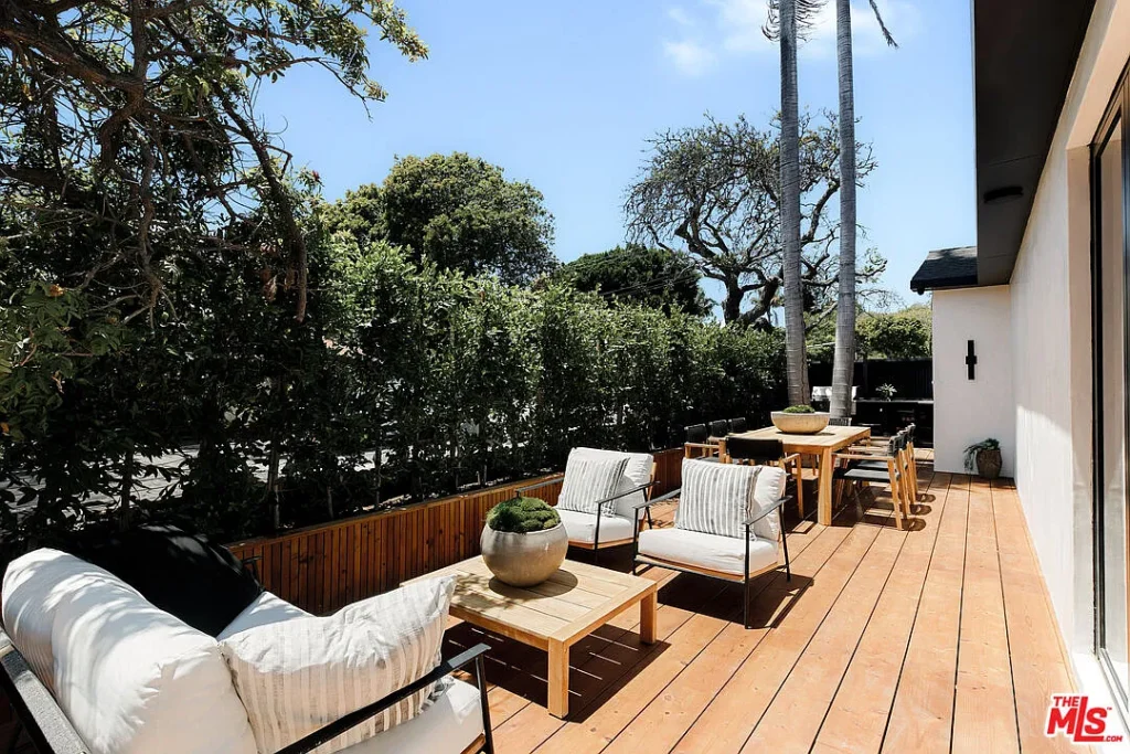 Modern outdoor deck at 2202 California Ave in Santa Monica featuring lounge seating, dining area, wood decking and landscaped surroundings